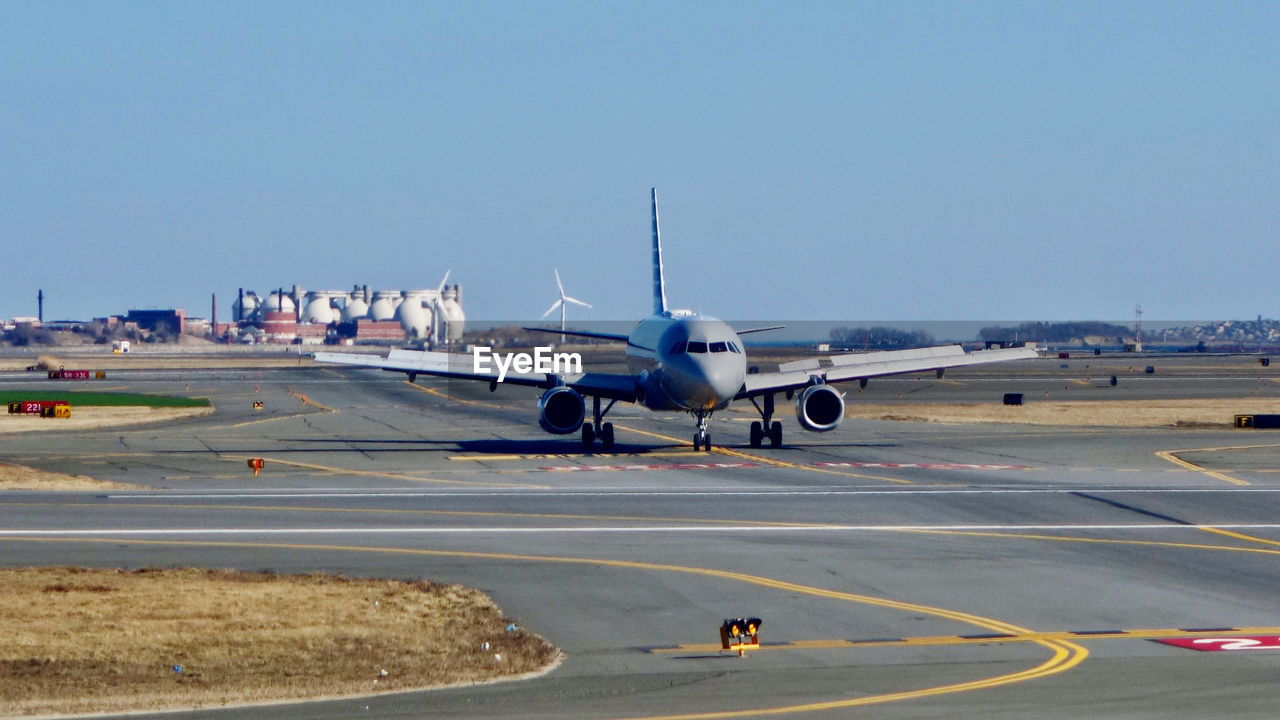 AIRPLANE ON RUNWAY AGAINST SKY