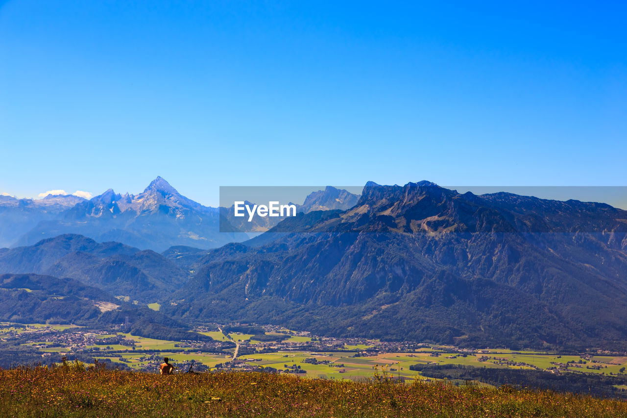 Scenic view of mountains against clear blue sky