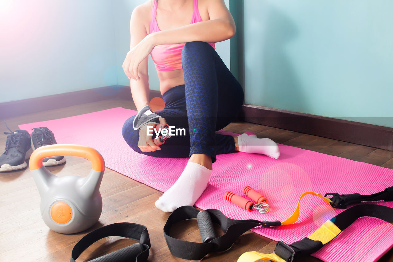 Low section of woman exercising on table