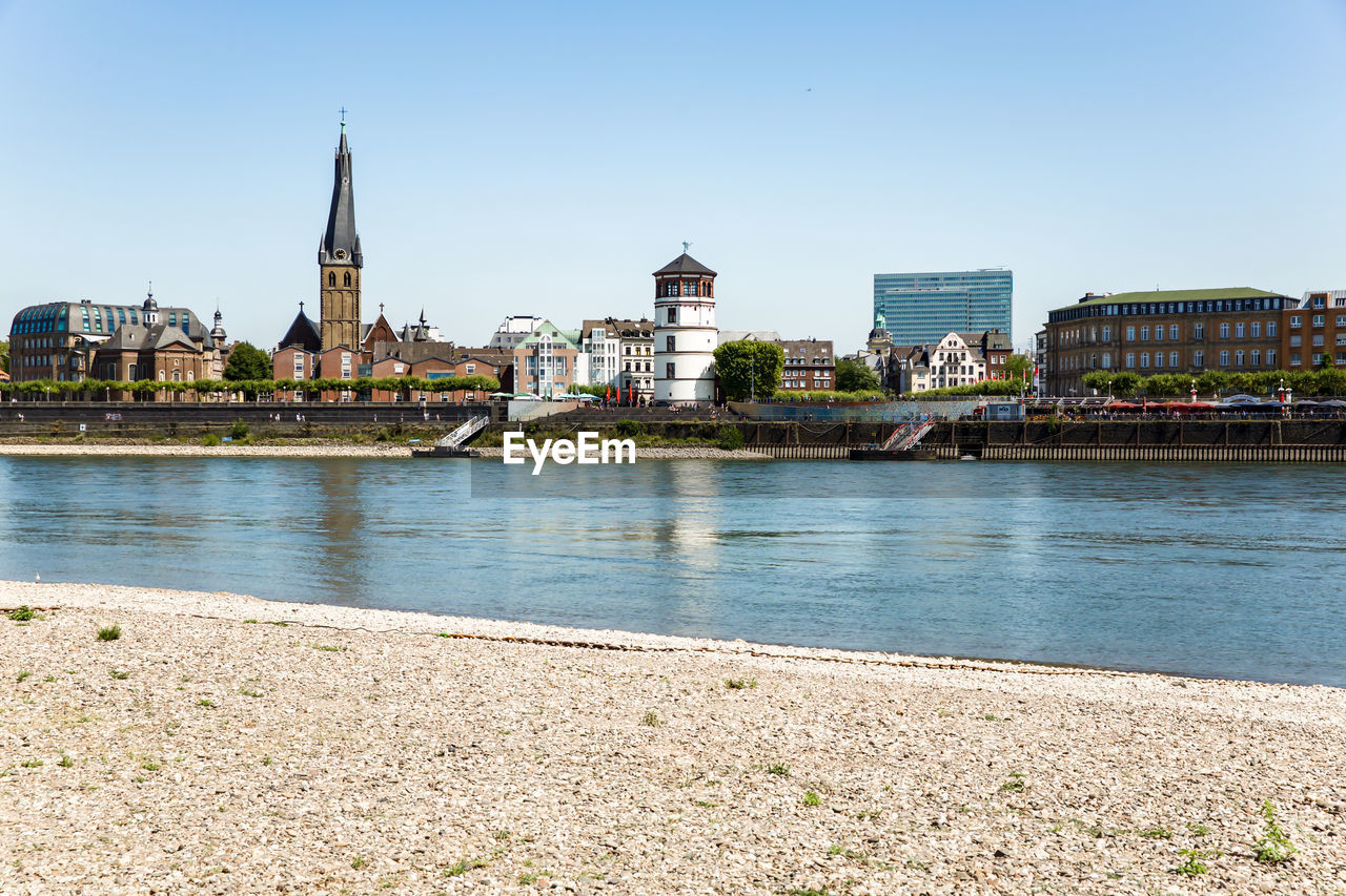 VIEW OF RIVER BY BUILDINGS AGAINST SKY