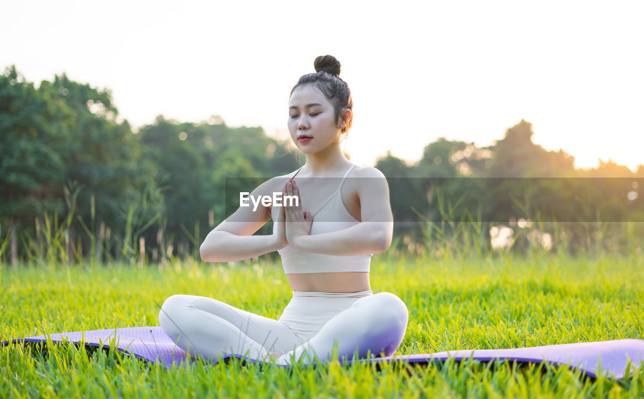 portrait of young woman sitting on grass