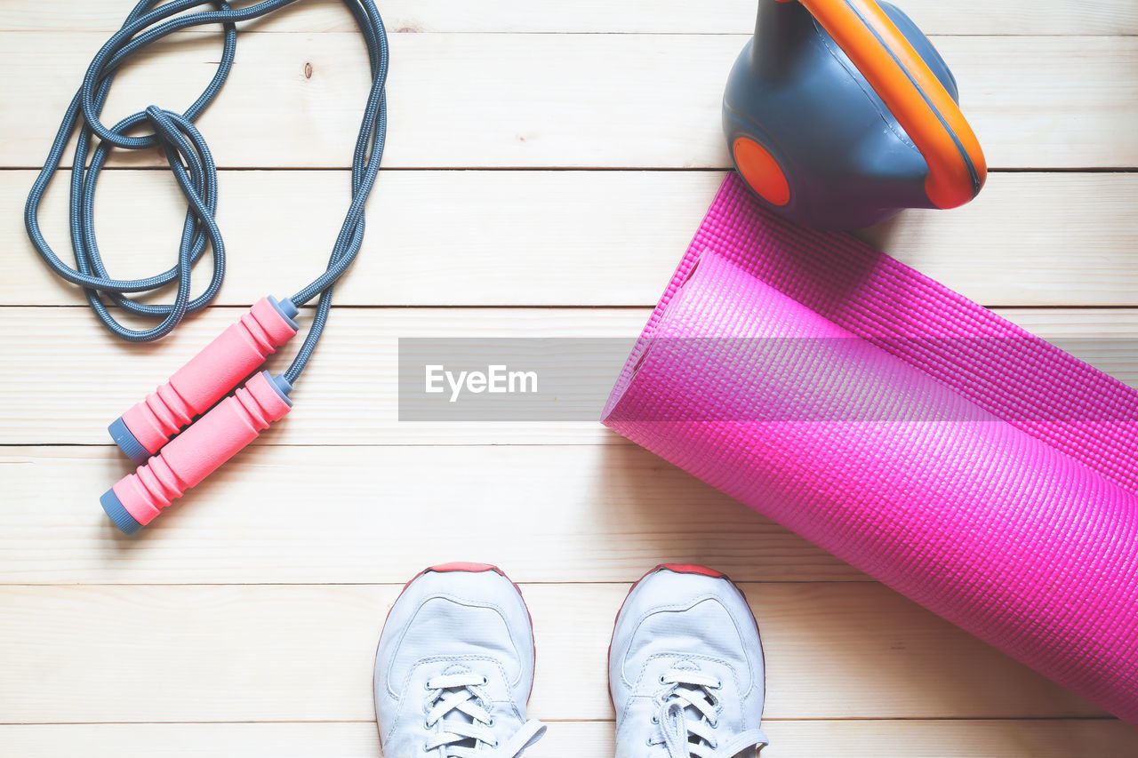 Directly above shot of exercise equipment on hardwood floor