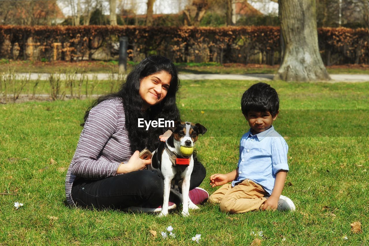 HAPPY FRIENDS SITTING IN PARK