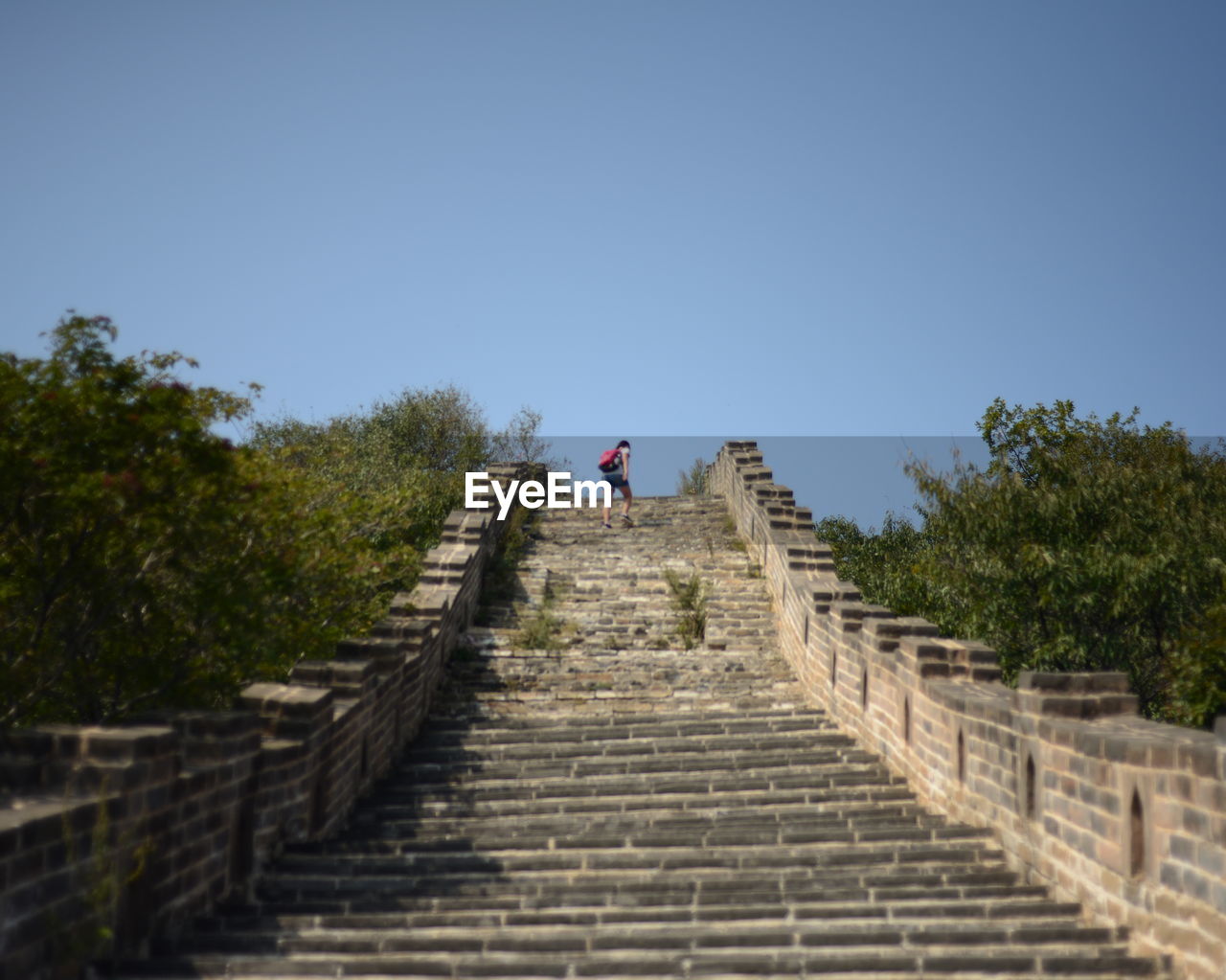 Woman at great wall of china against clear sky