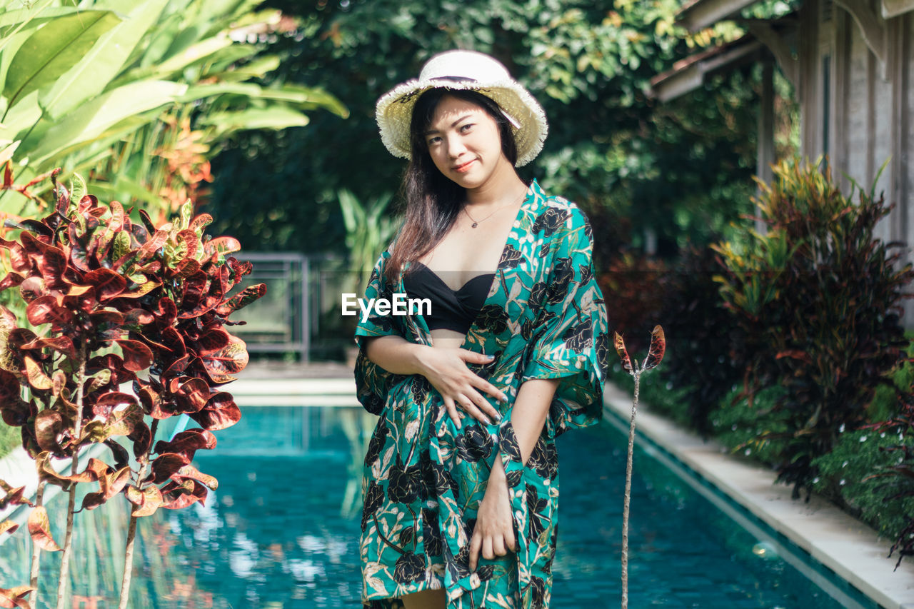 Young woman standing in swimming pool