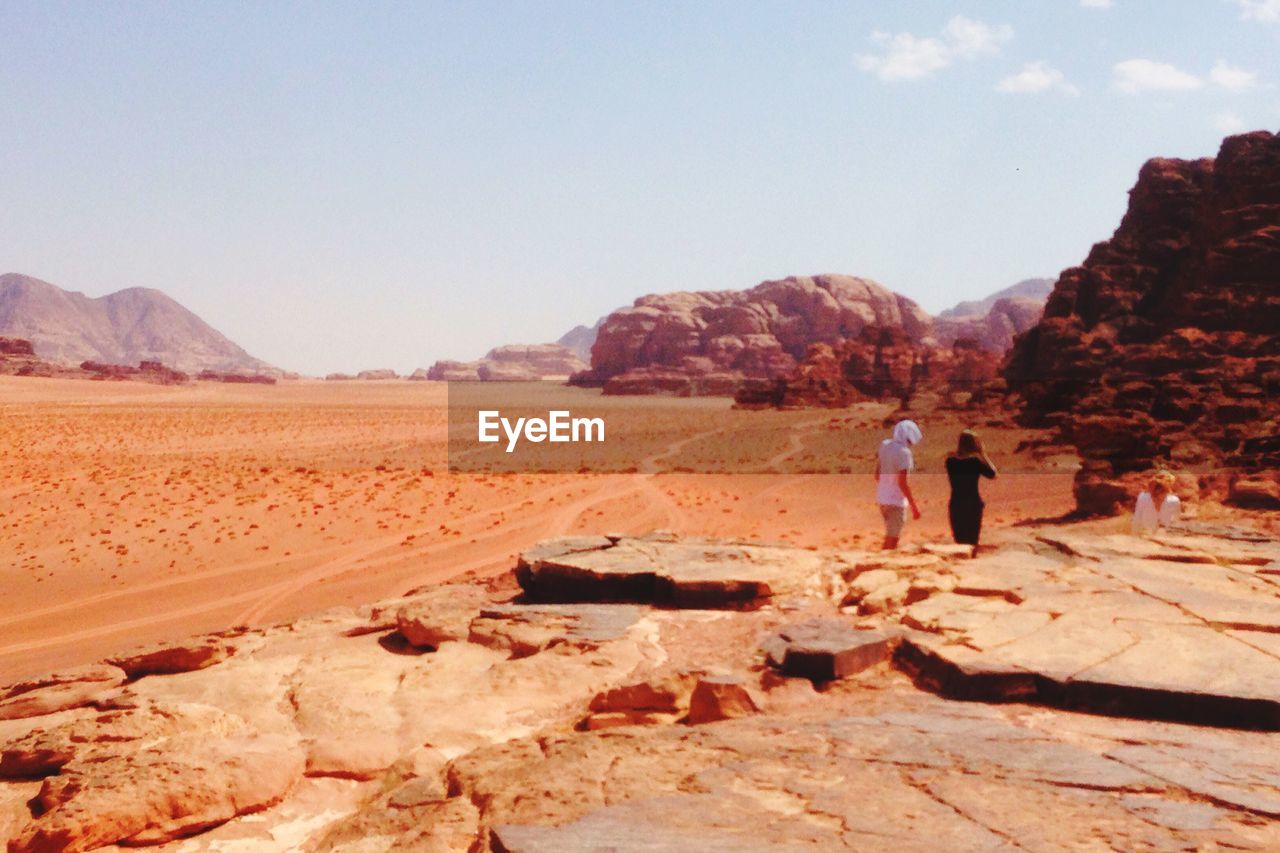 WOMAN STANDING ON ROCK FORMATION