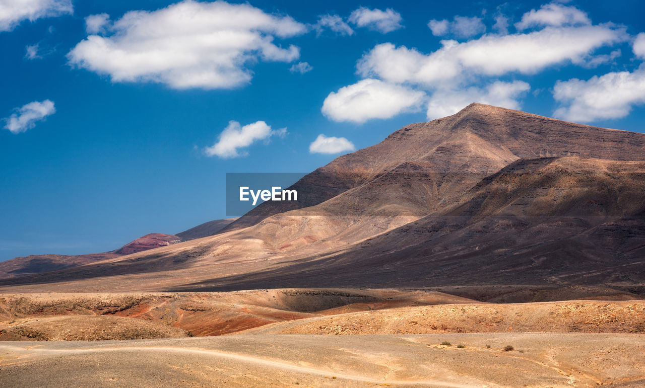 Scenic view of arid landscape on lanzarote against sky