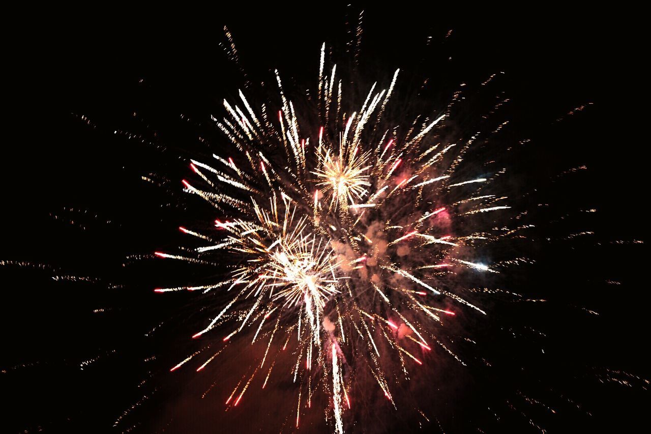 High angle view of firework display at night