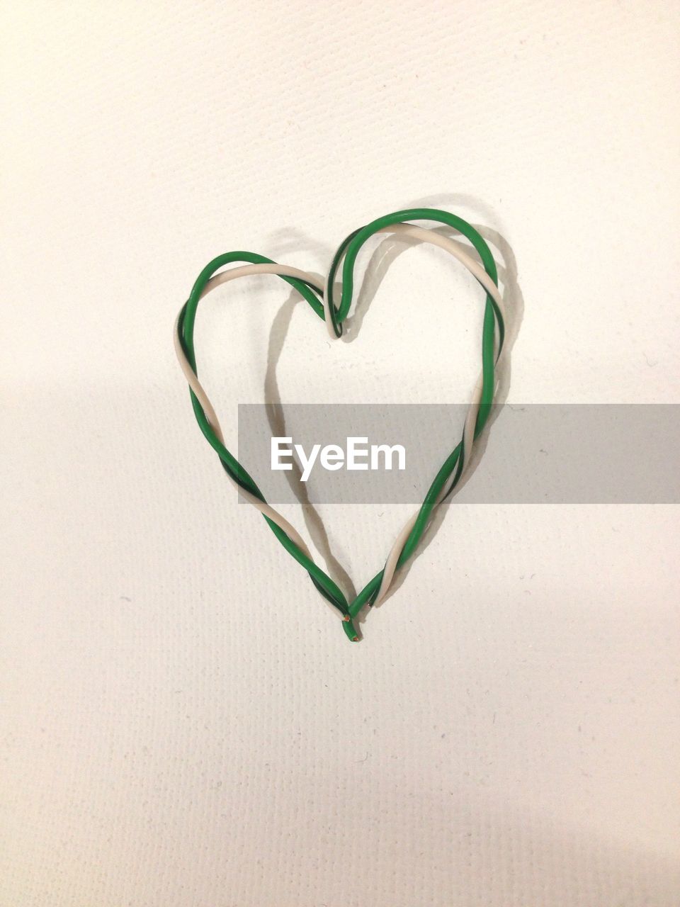 Close-up of heart shaped object over white background