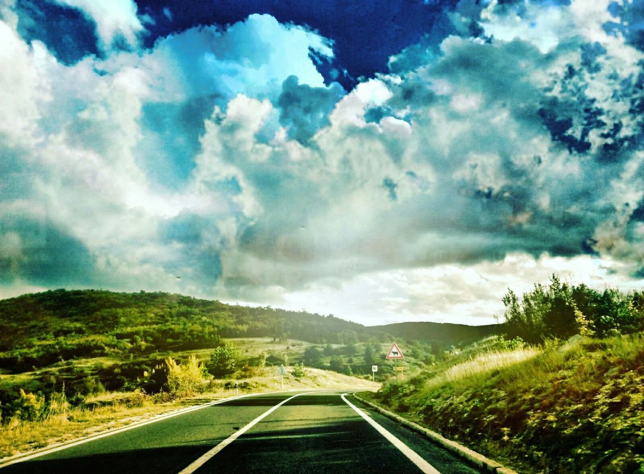 VIEW OF ROAD AGAINST CLOUDY SKY