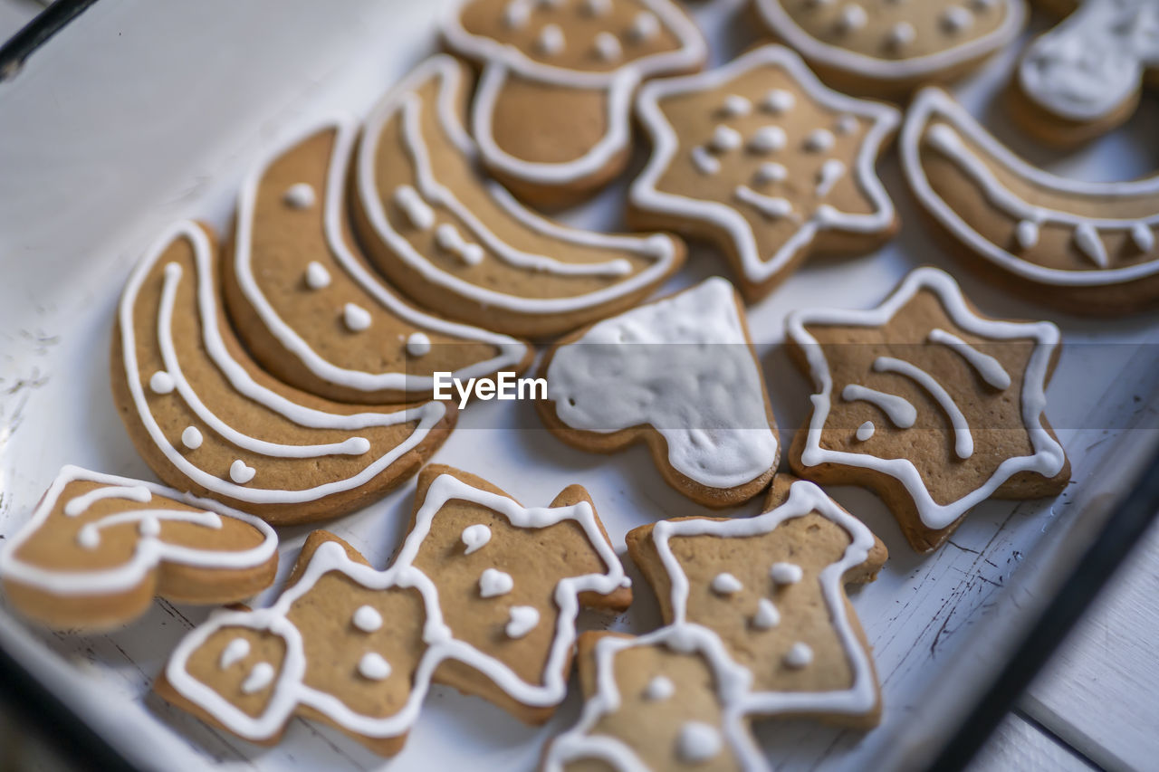 High angle view of ginger bread, christmas  cookies in cake pan on table.