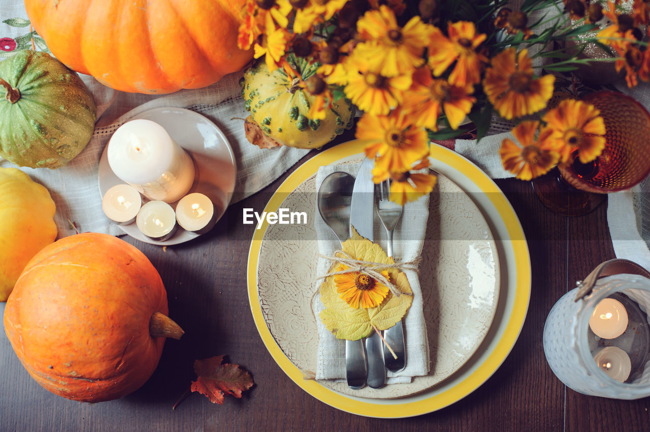 Directly above shot of plate by flowers on table