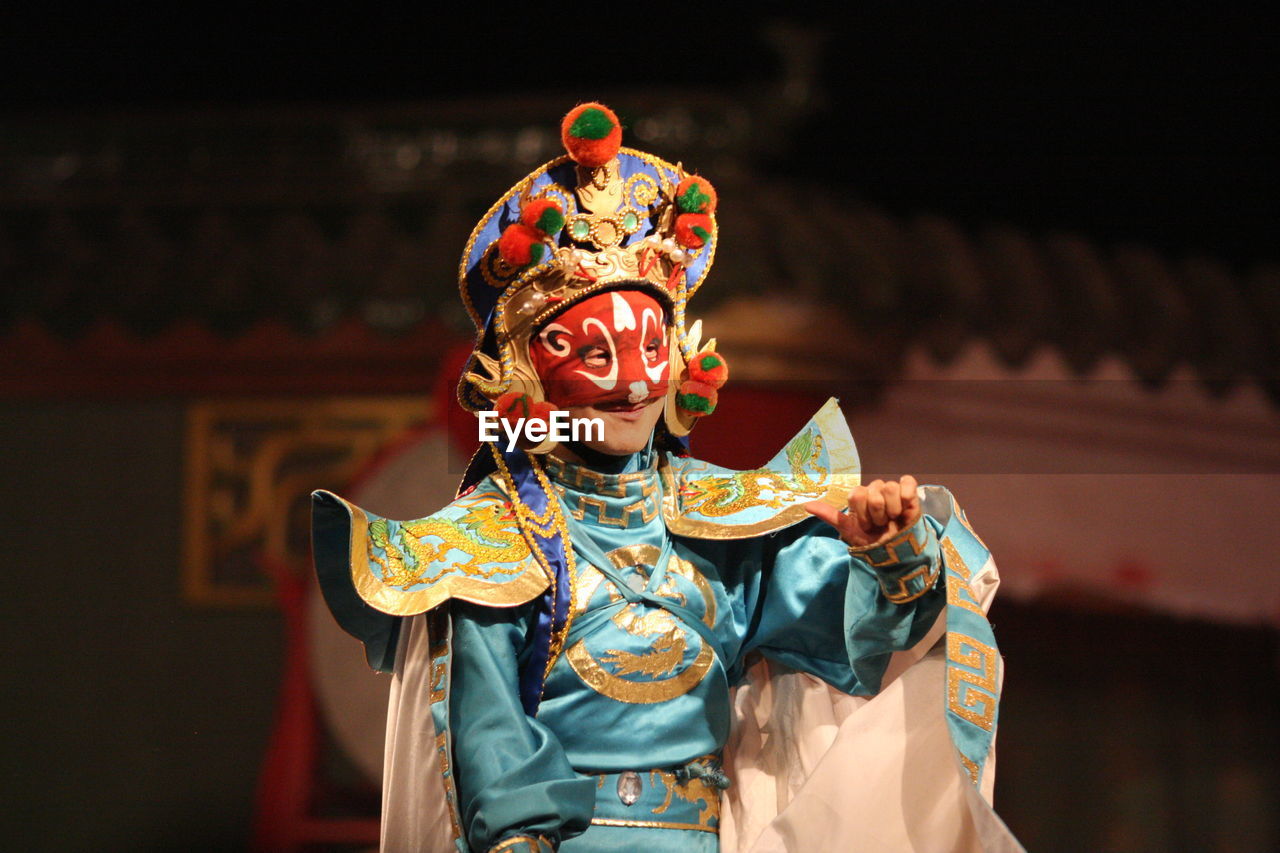 Close-up of woman in costume standing on stage