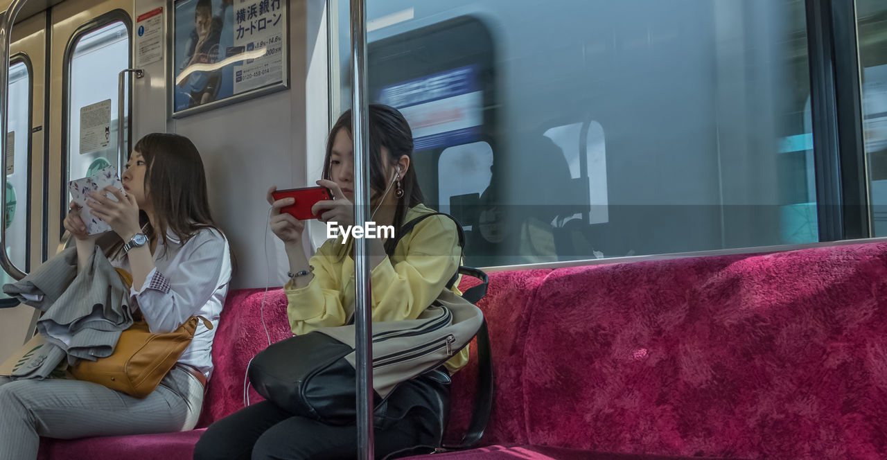 PEOPLE SITTING AT TRAIN