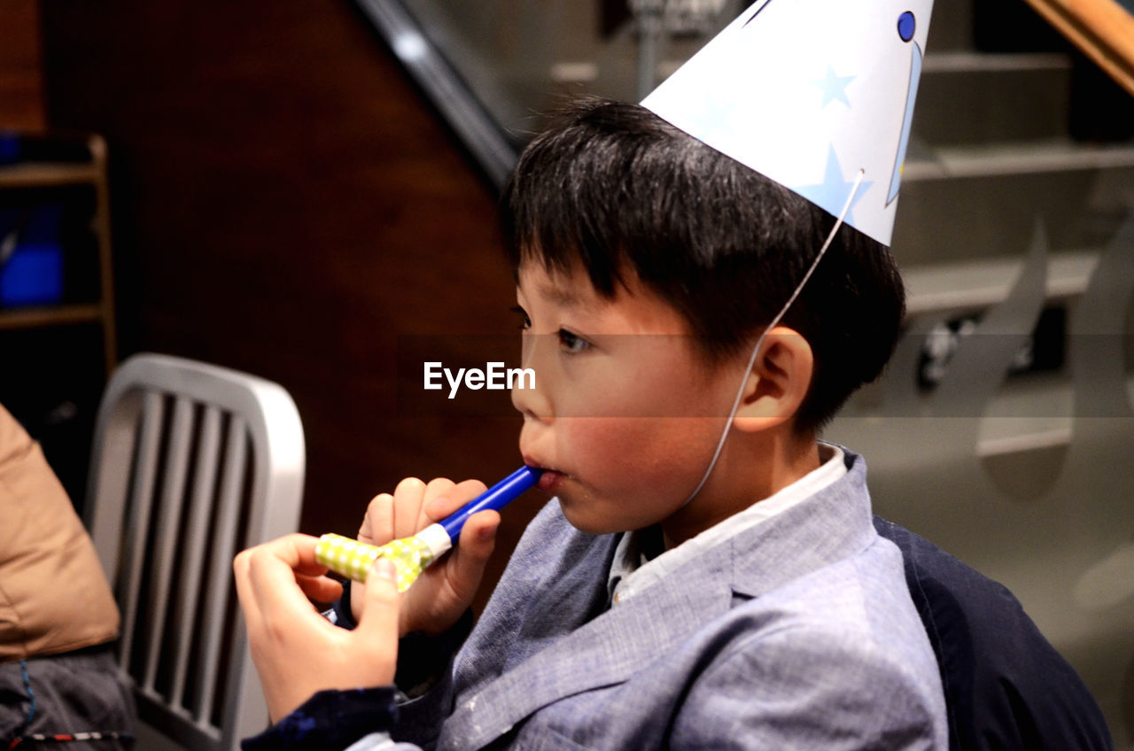 Portrait of boy holding at birthday celebration