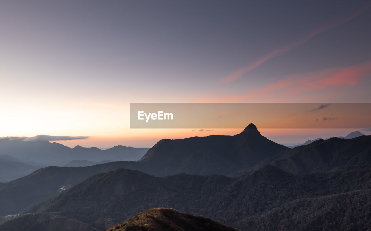 Scenic view of silhouette mountains against sky during sunset