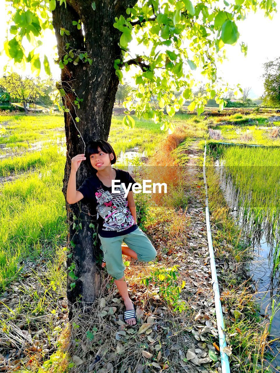 Full length of girl standing by trees