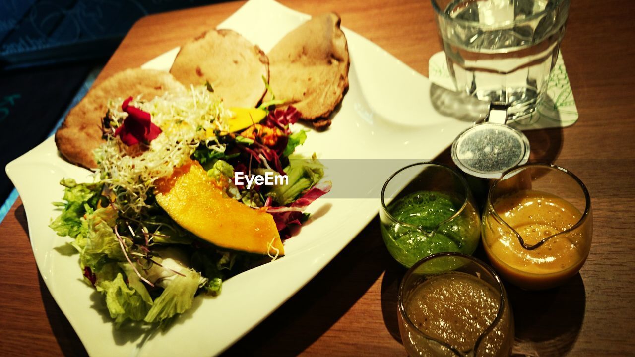 CLOSE-UP OF SERVED FOOD ON TABLE