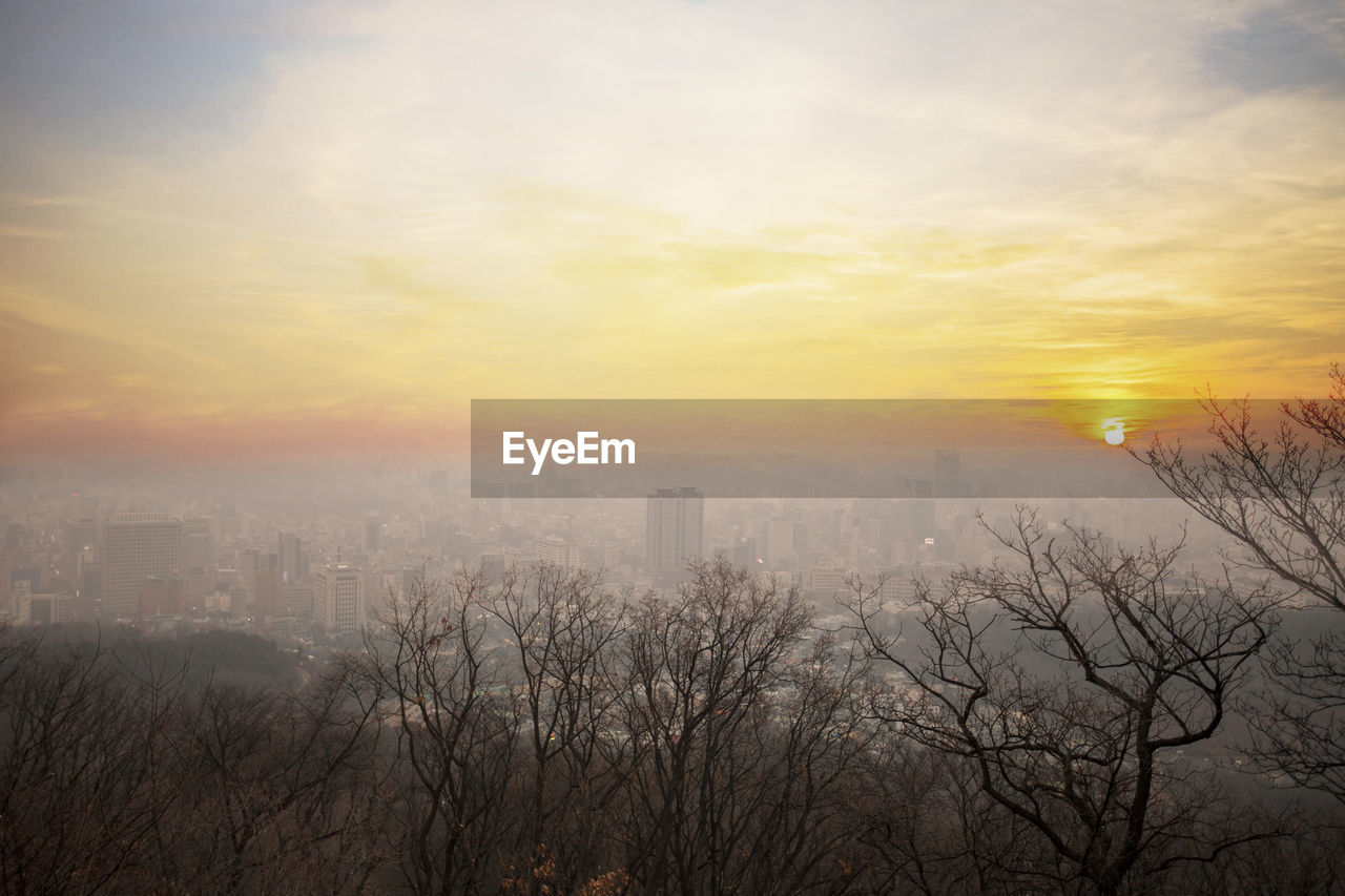 Scenic view of buildings against sky during sunset