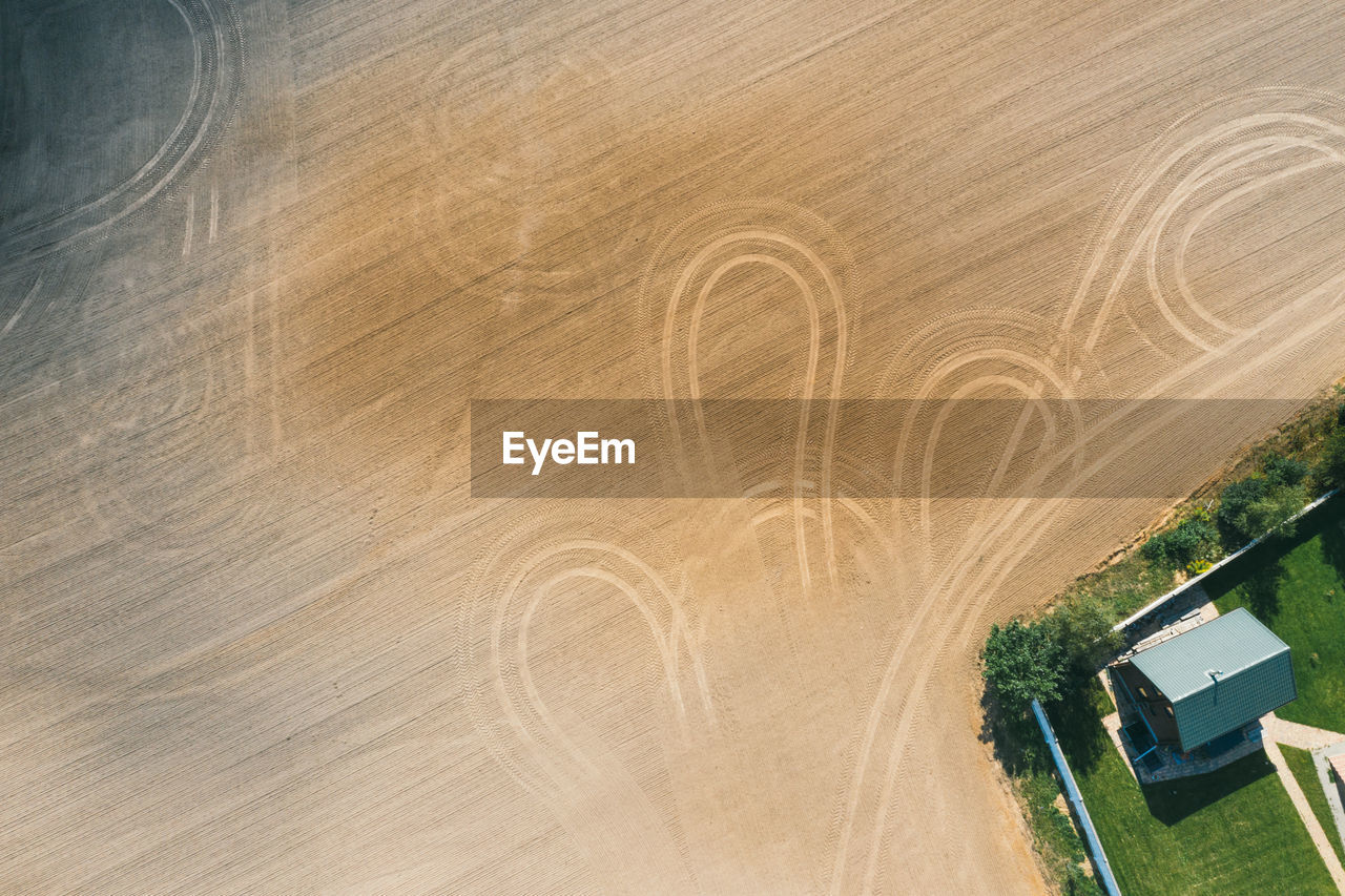 Picture of an aerial view with a drone of a field and field with tractor tracks