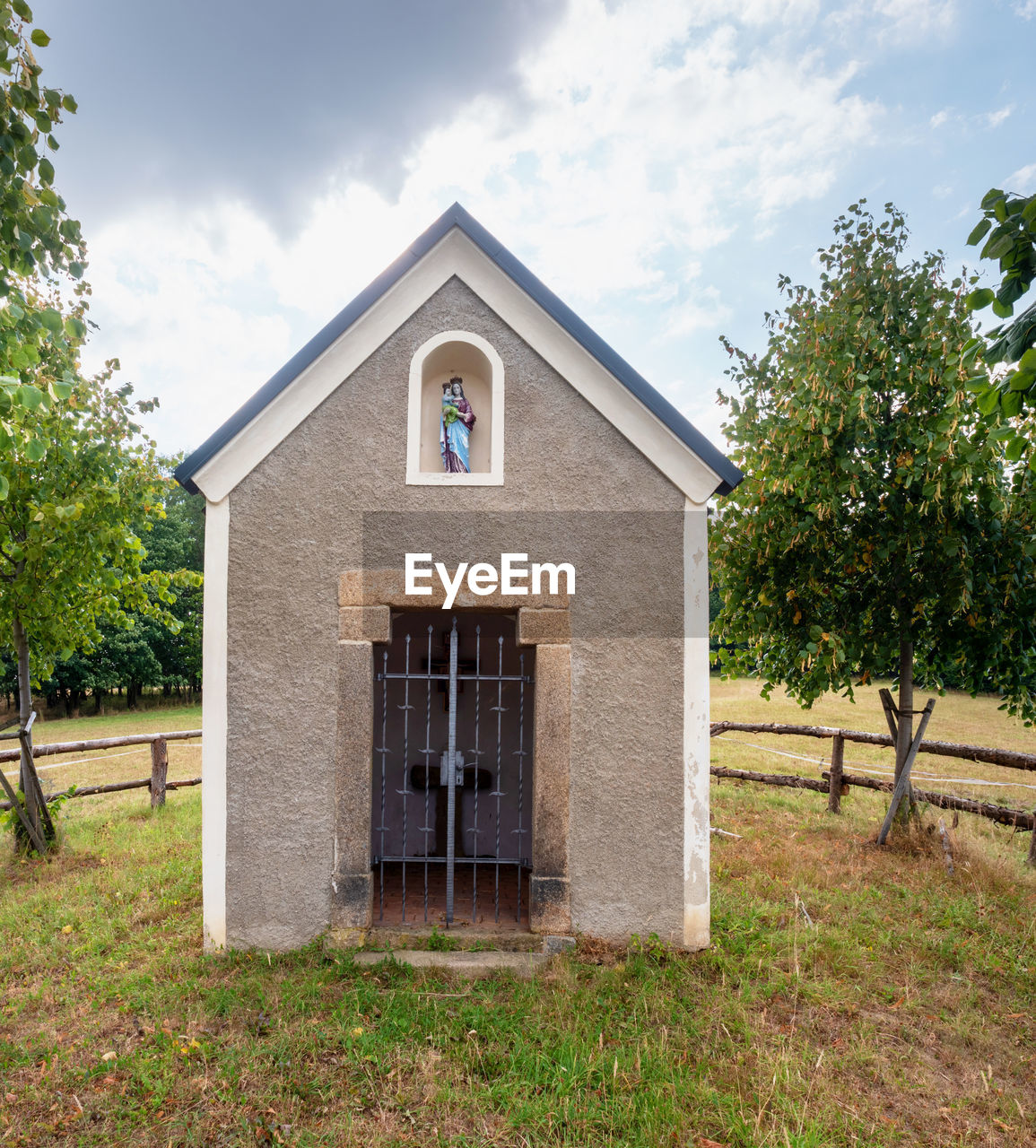 The small botzen chapel at basalt mine, sluknov, czechia. renewal chapel in middle of cow pasture