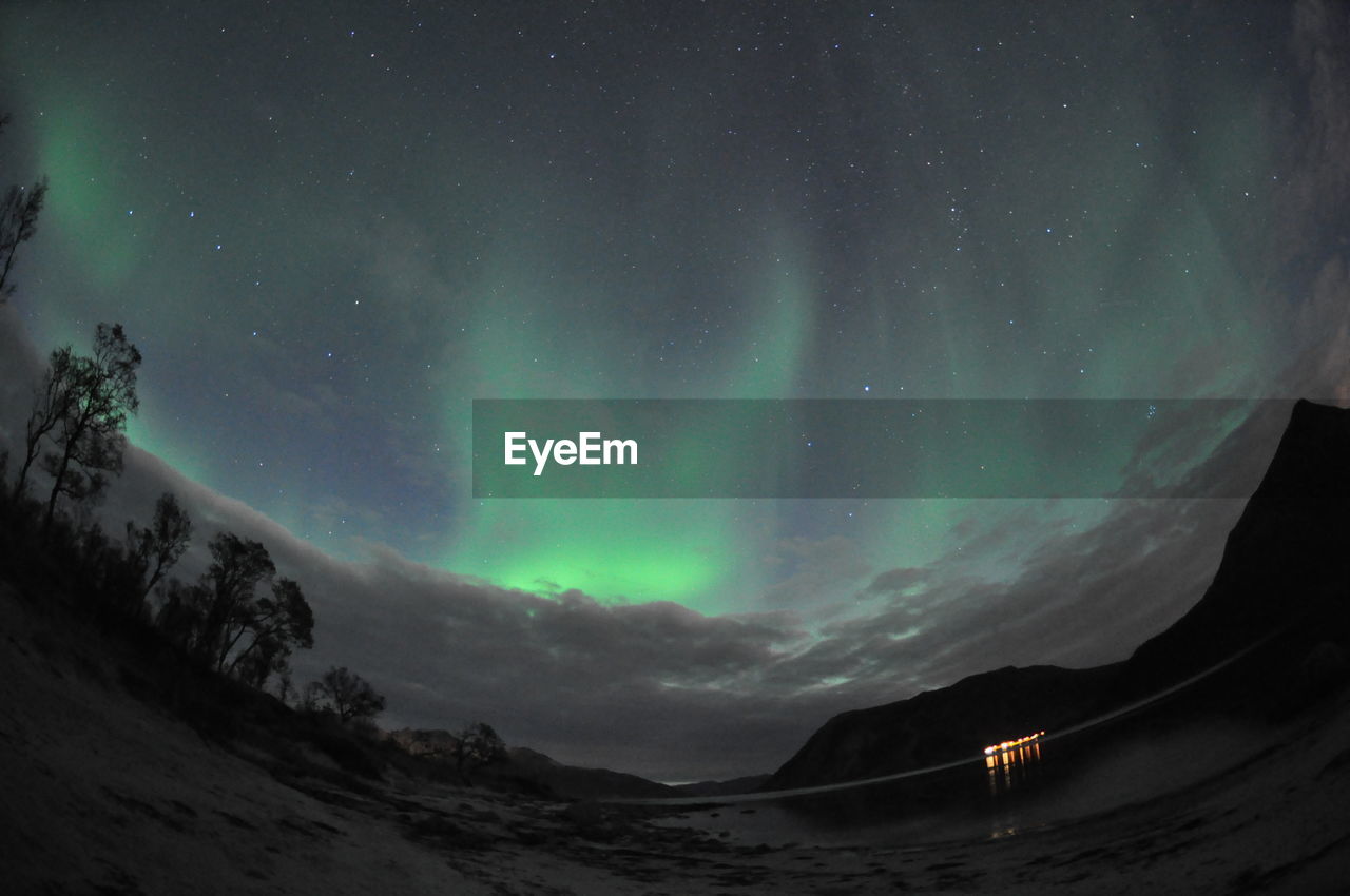 Scenic view of landscape against sky at night