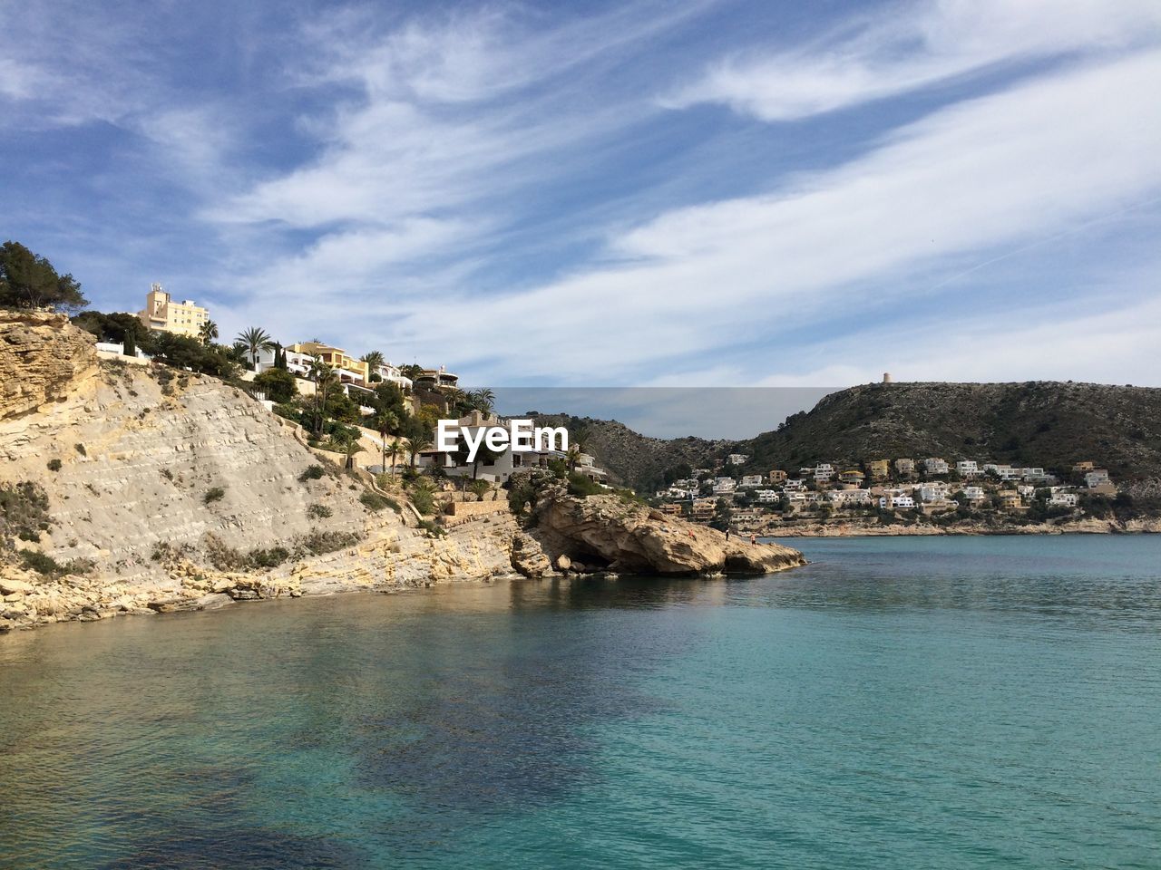 Scenic view of sea and mountains against sky