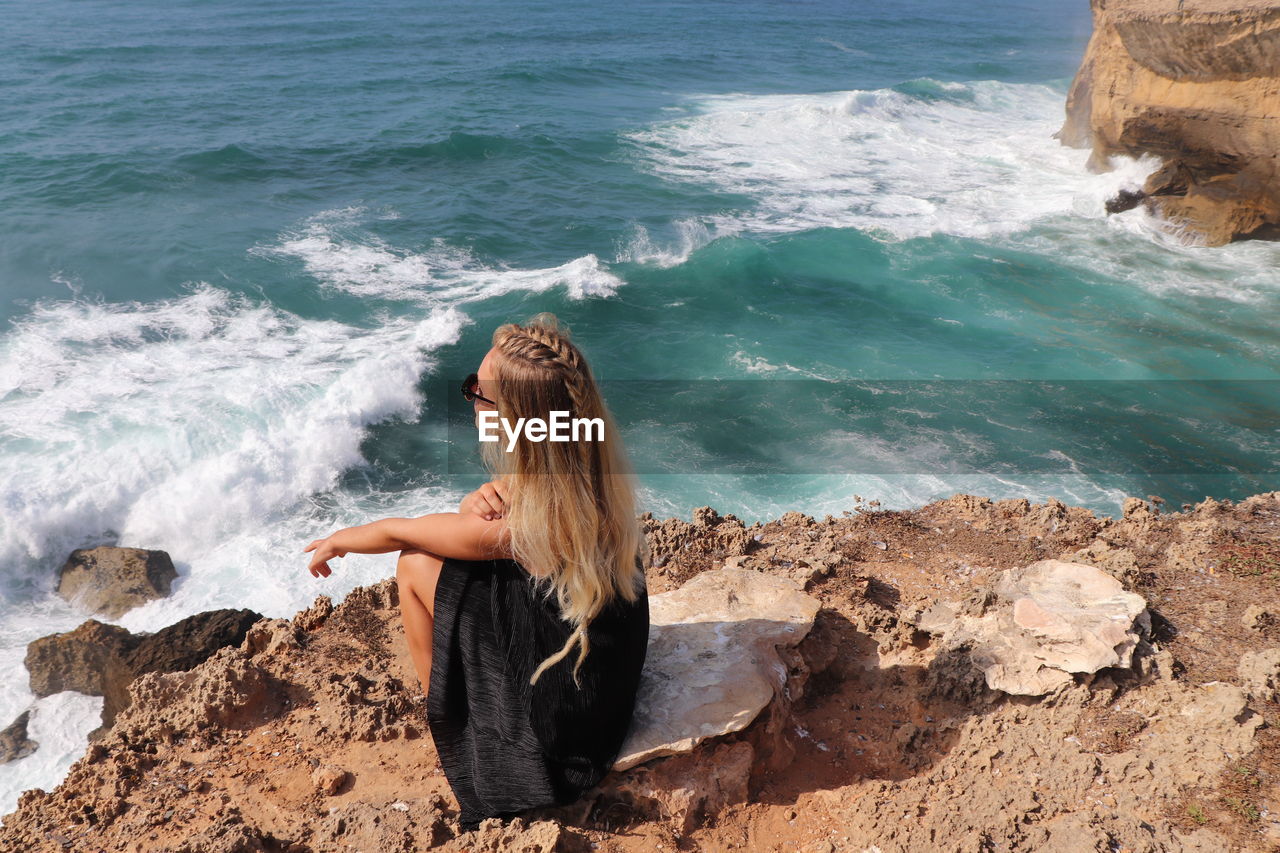 Woman on rock at beach