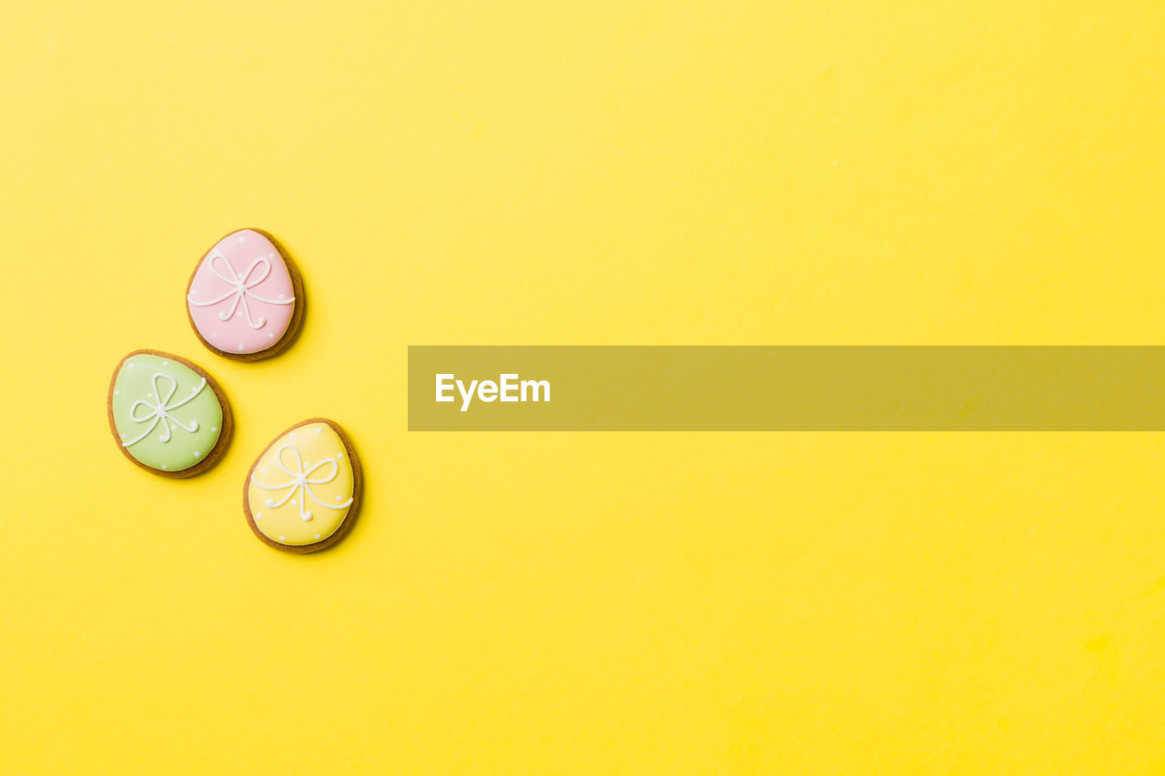 directly above shot of pills on yellow background