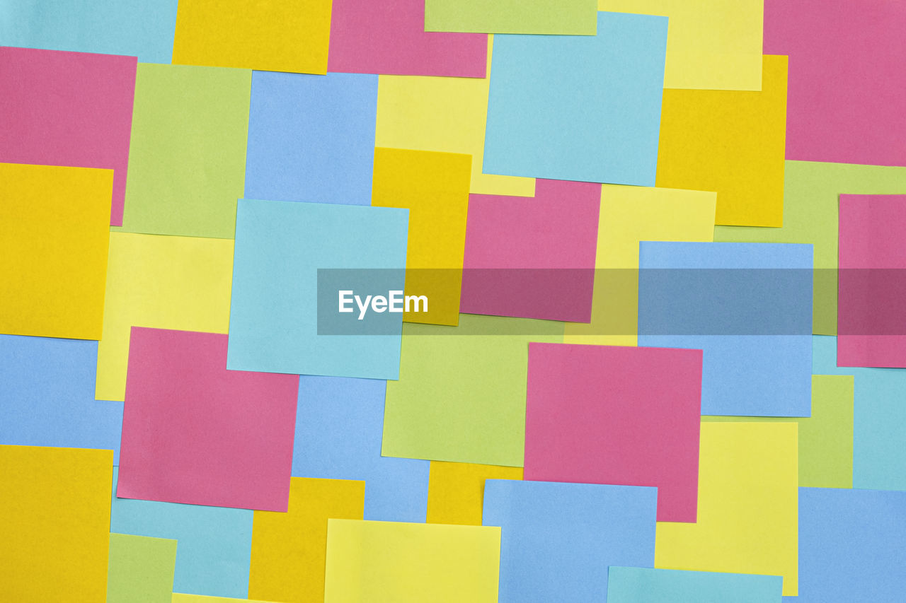 Multicolored sticky paper notes texture background, full frame