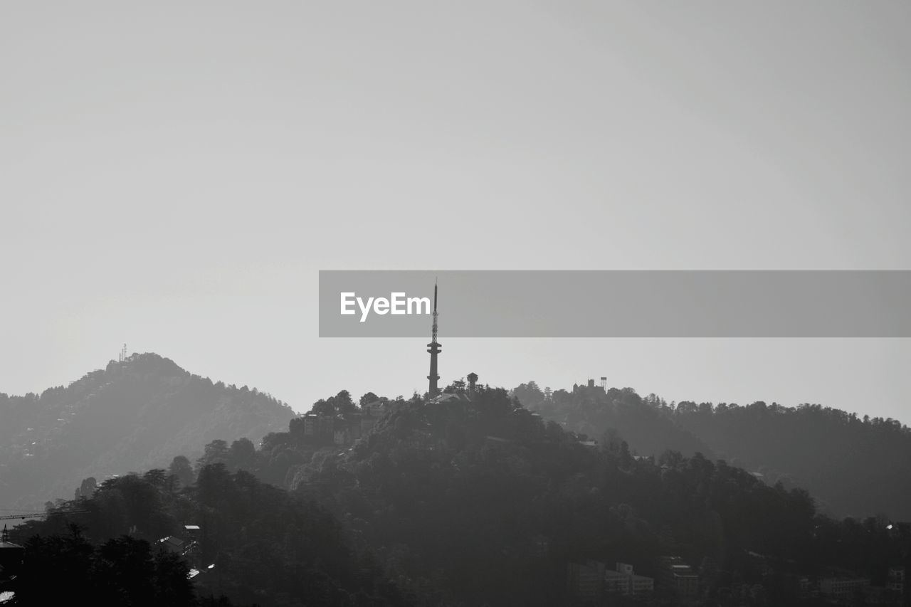 Low angle view of communications tower against sky