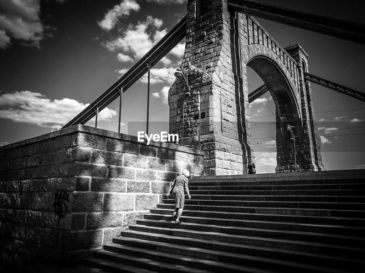 LOW ANGLE VIEW OF STAIRCASE AGAINST SKY IN CITY