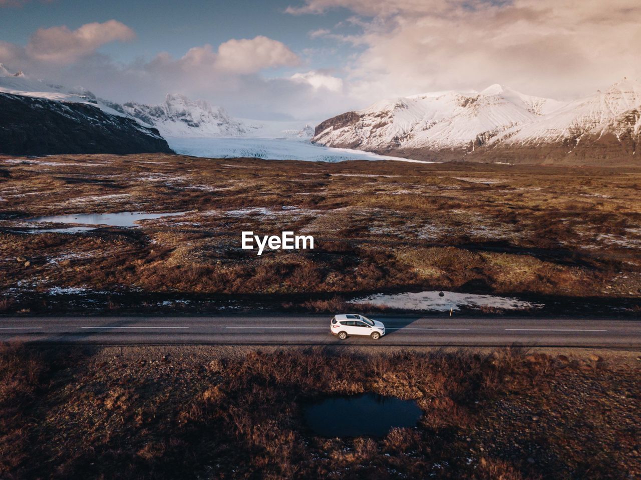 AERIAL VIEW OF SNOWCAPPED MOUNTAIN AGAINST SKY