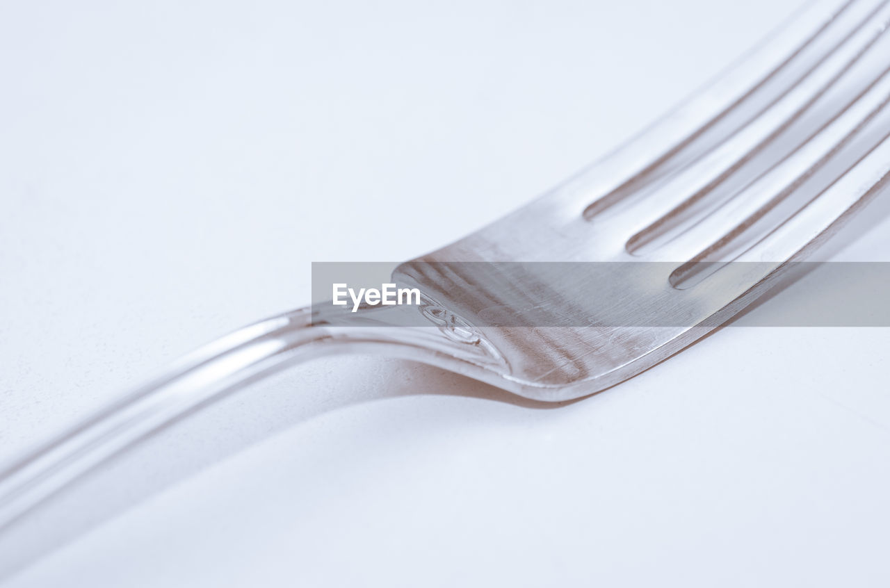 Close-up of fork against white background