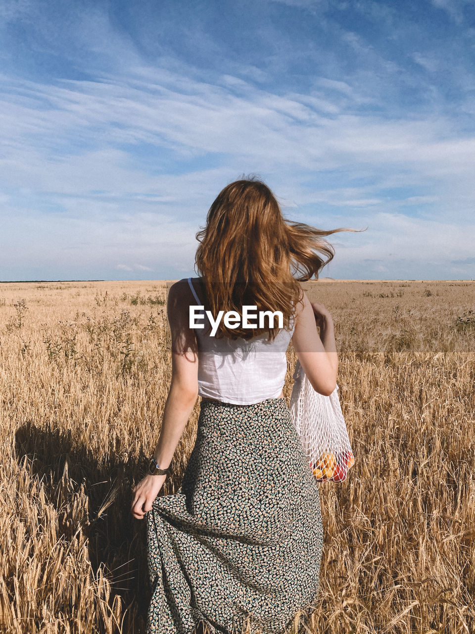 WOMAN STANDING ON FIELD