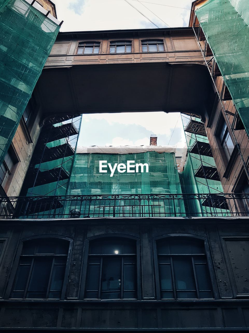 Low angle view of modern building in city against sky