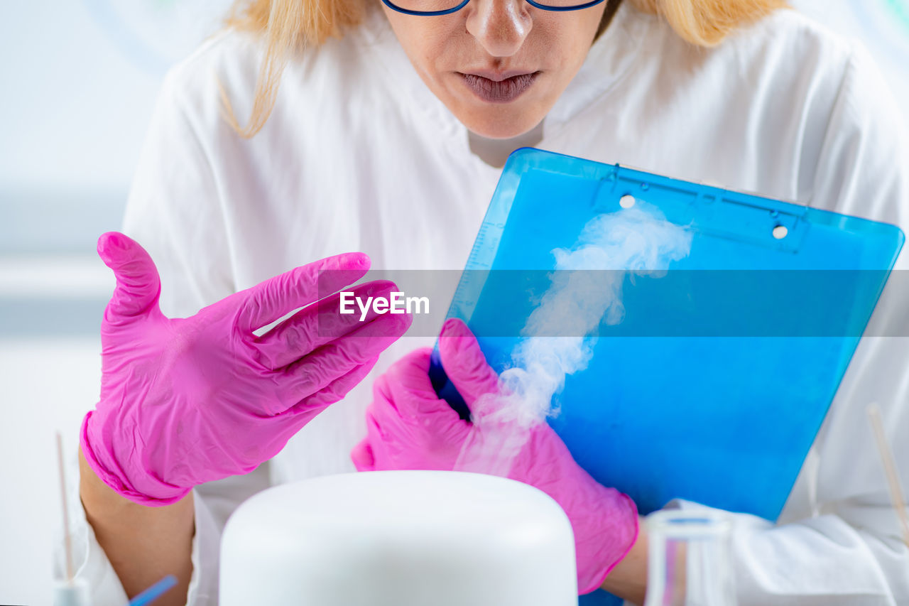 Olfactory lab scientist taking notes during aroma essential oil test