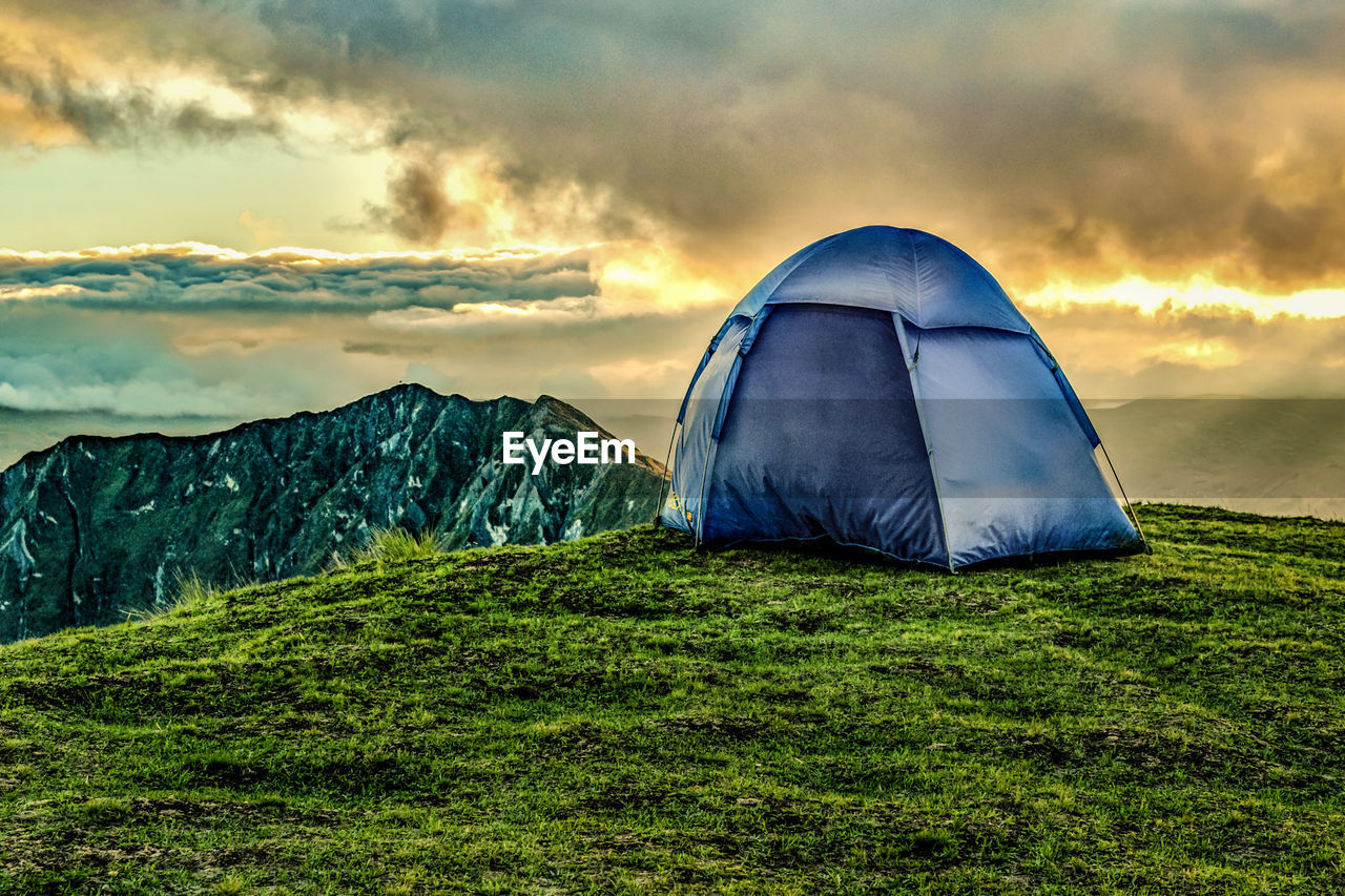 TENT IN MOUNTAINS