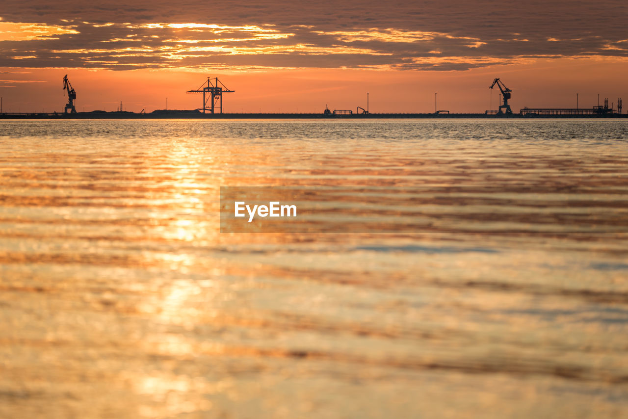 Scenic view of sea against orange sky