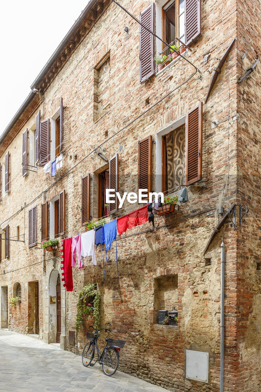 Italian alleyway with hanging laundry and a parked bicycle