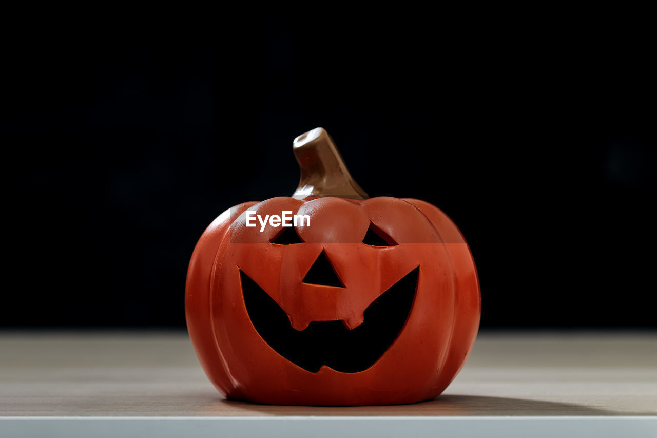 CLOSE-UP OF PUMPKIN FACE ON TABLE