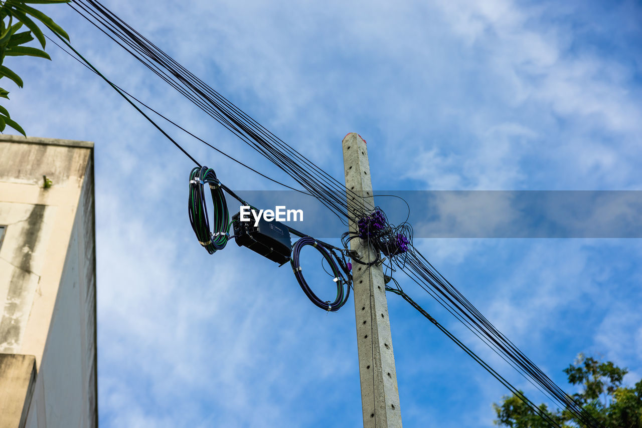 Low angle view of electricity pylon against sky