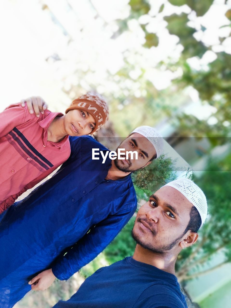 PORTRAIT OF SMILING YOUNG COUPLE OUTDOORS