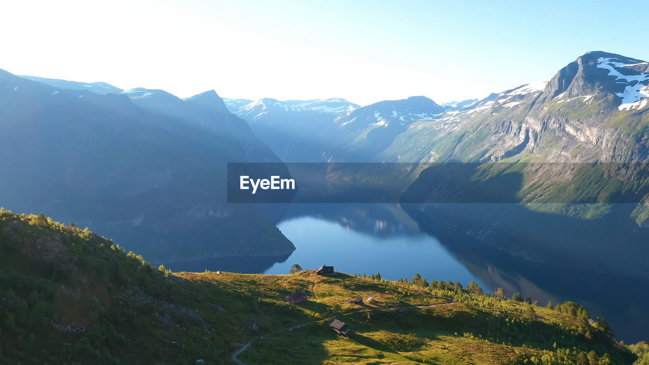 Scenic view of lake and mountains against sky