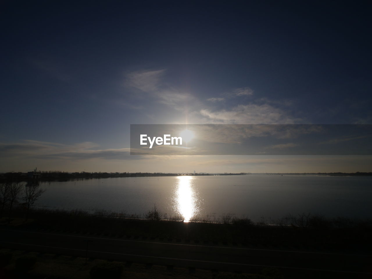 SCENIC VIEW OF SUNSET OVER LAKE