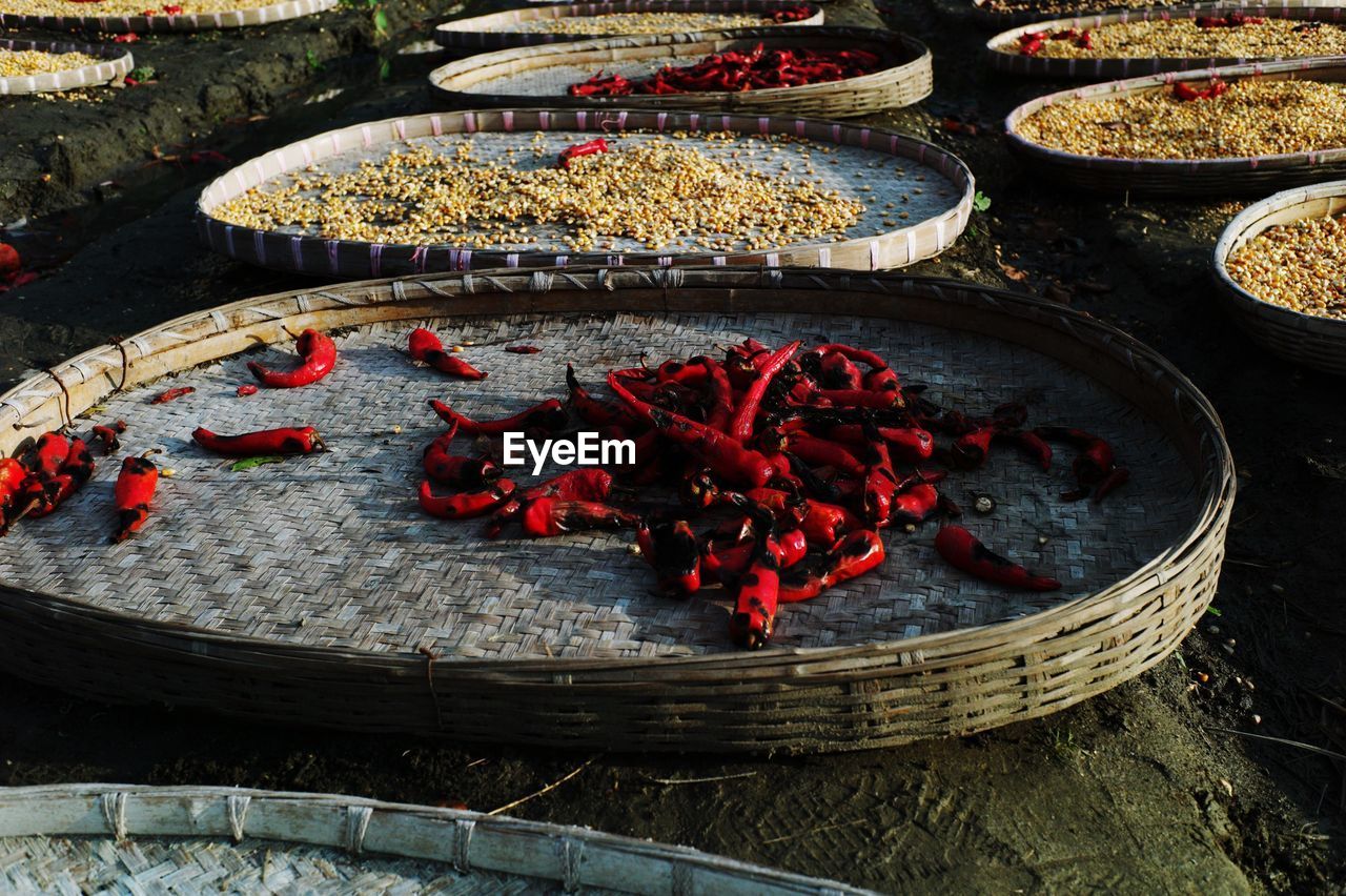 Spices in wicker trays drying outdoors