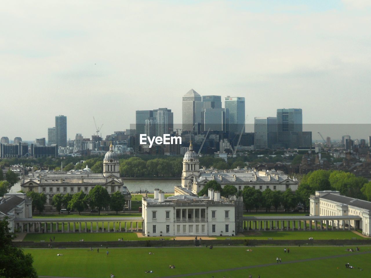 View of cityscape against cloudy sky