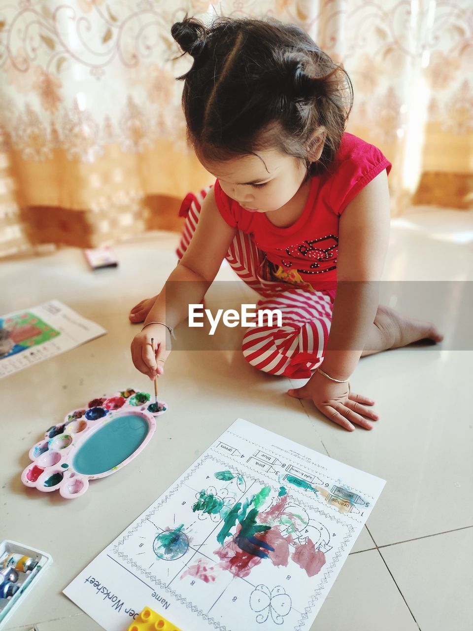 High angle view of girl holding paper