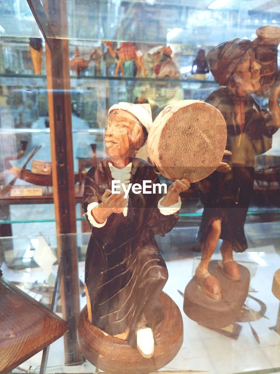 REFLECTION OF MAN IN GLASS WINDOW AT STORE