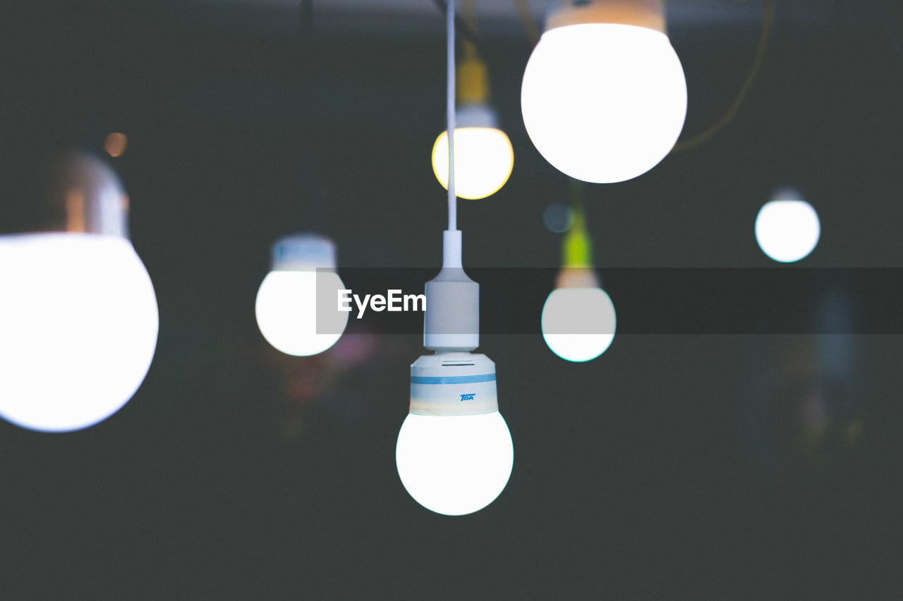 Illuminated light bulbs hanging at home